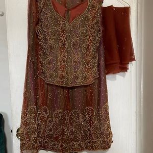 Beautiful Indian 3 piece lehenga in rust color with embellished work